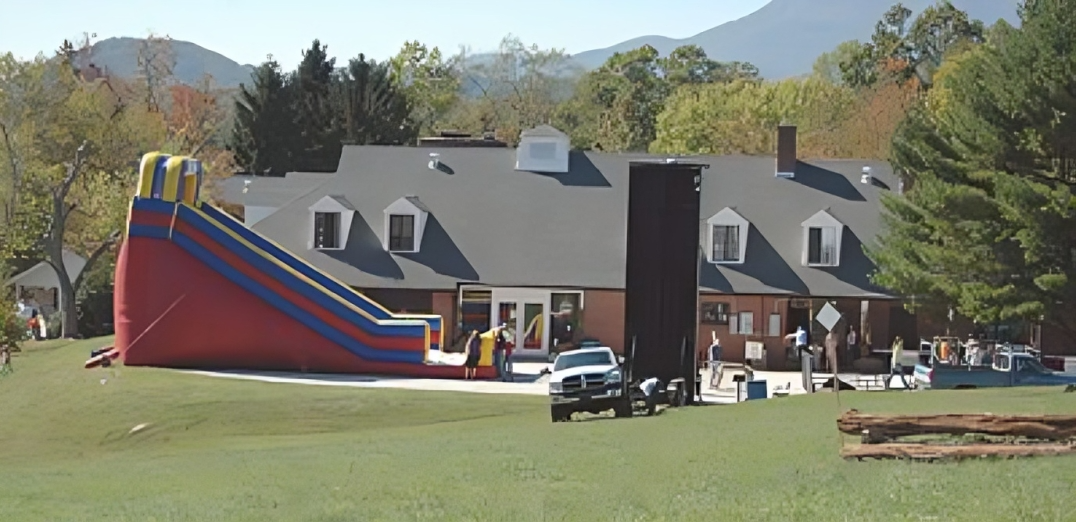 Large inflatable slide near a house