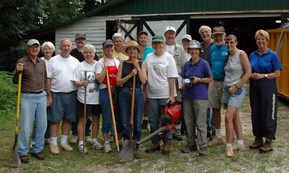 People posing with gardening equipment