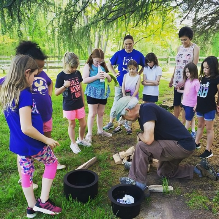 Children watching outdoor activity demonstration