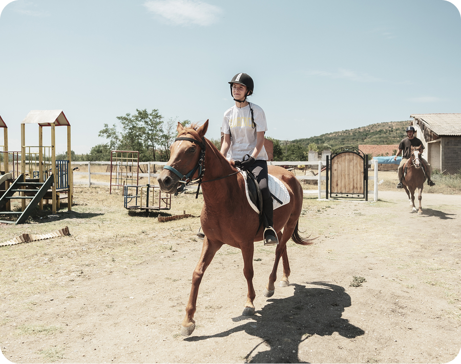 Equestrian practicing in outdoor riding area