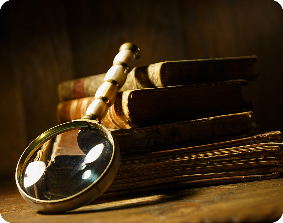 Magnifying glass and vintage books