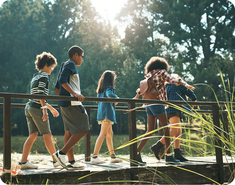 Children walking on a wooden bridge