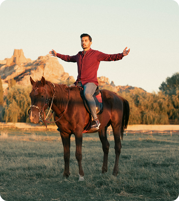 Rider with outstretched arms on horse