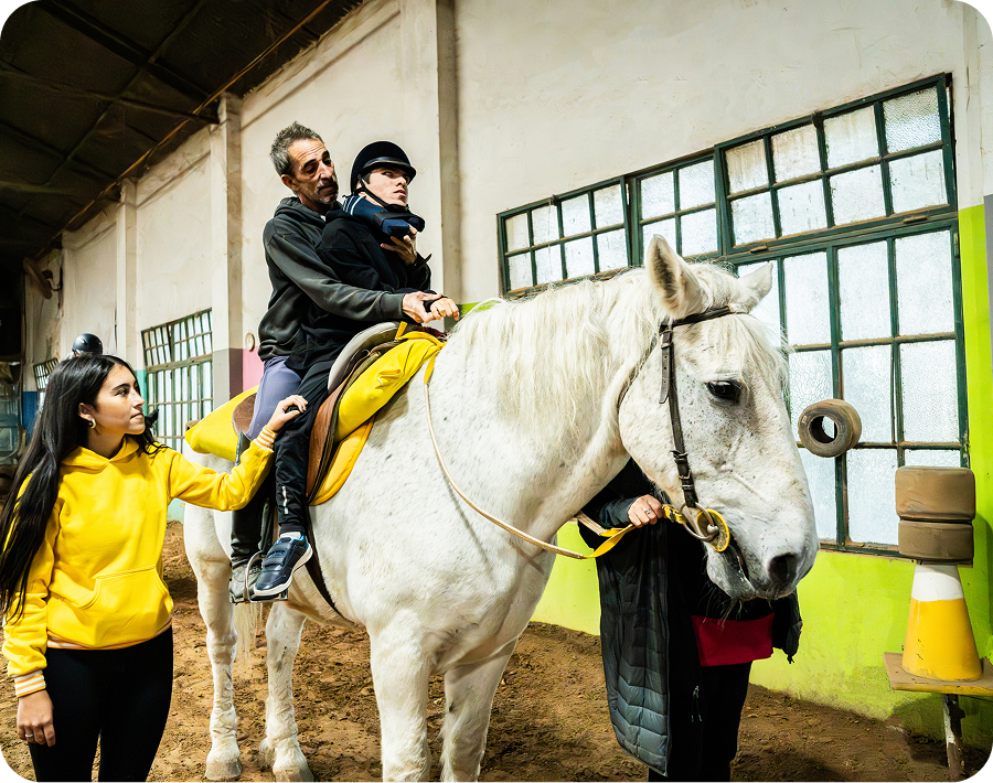 Therapeutic horseback riding with assistance
