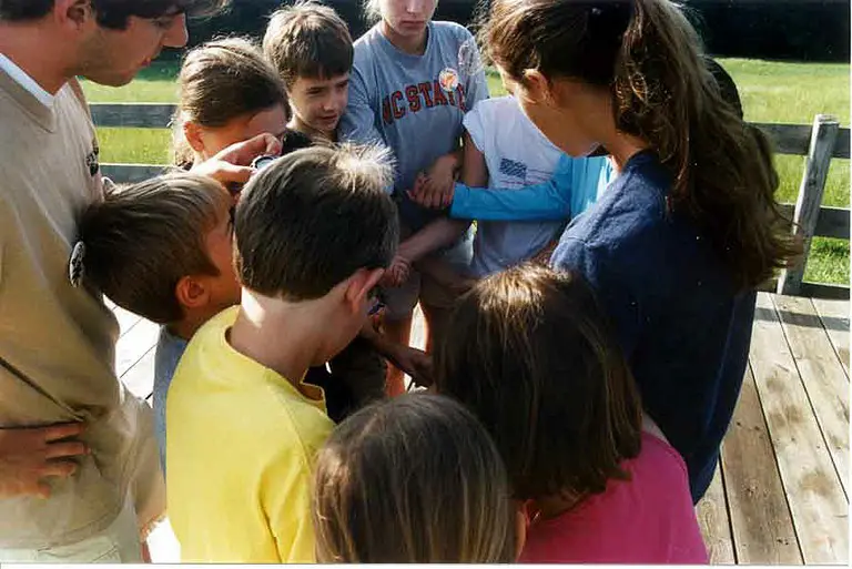 Kids and adults gathered on wooden deck