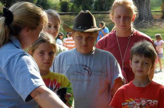 Kids gathered around a woman instructor
